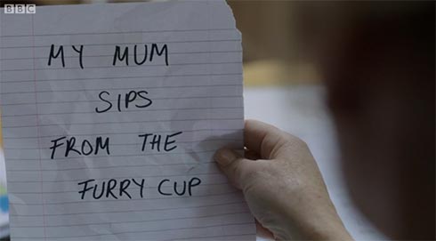 a note that says "Your mum sips from the furry cup."