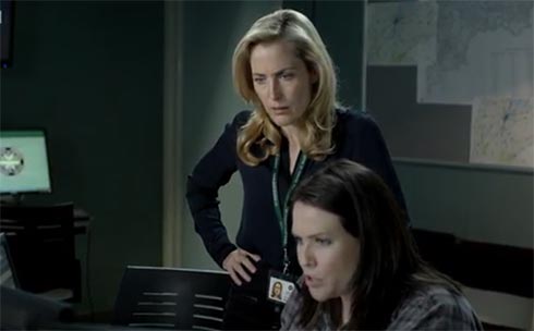 Gillian Anderson watching monitors with Control
