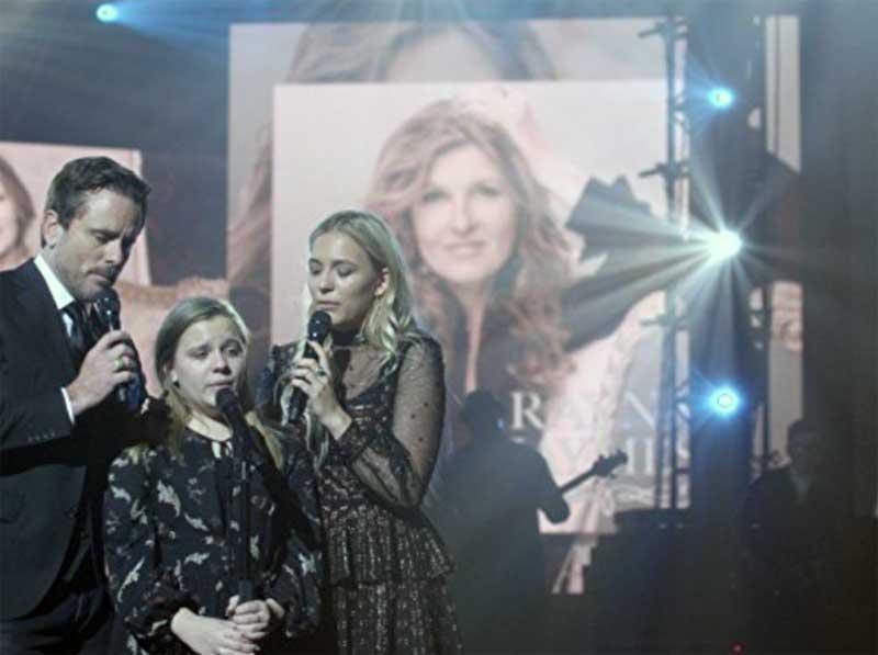 Charles Esten, Maisy Stella and Lennon Stella in front of a poster sized image of Connie Britton in Nashville