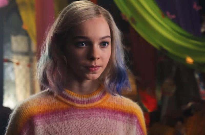 Emma Myers in a colorful sweater in Wednesday