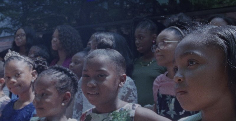 A group photo of the daughters dressed in their best waiting to spend time with their dads.